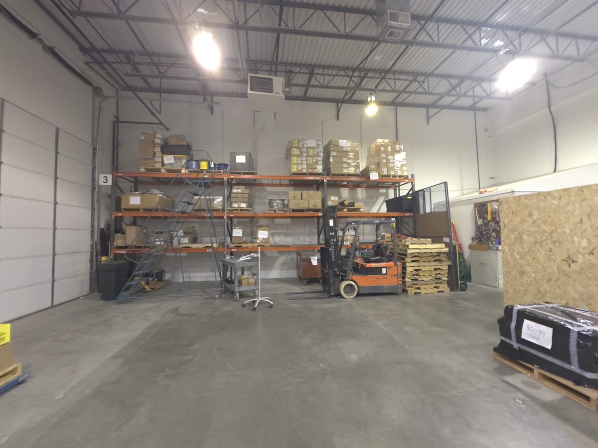 Active warehouse space with forklift, pallet racking and inventory